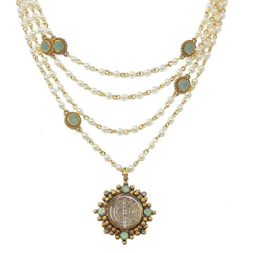 Multi-strand pearl necklace with gold accents and a detailed medallion pendant.
