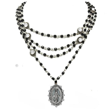Layered black beaded necklace with silver accents and a Miraculous Medal pendant.
