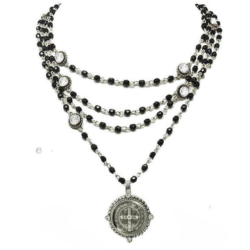 Layered black beaded necklace with silver accents and a detailed medallion pendant.
