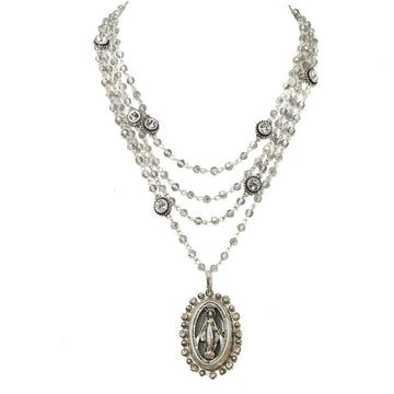 Layered silver necklace with clear crystal beads and a Virgin Mary pendant.
