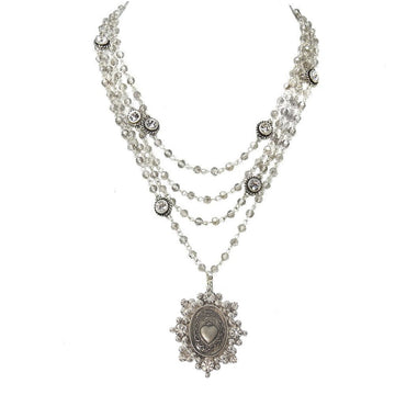 Multi-strand necklace with crystal beads and a silver heart pendant.
