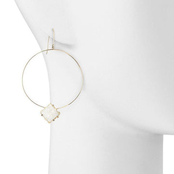 Gold hoop earrings featuring a textured moonstone detail.
