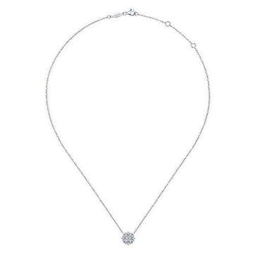Dainty diamond pendant necklace with a cluster setting on a delicate chain.
