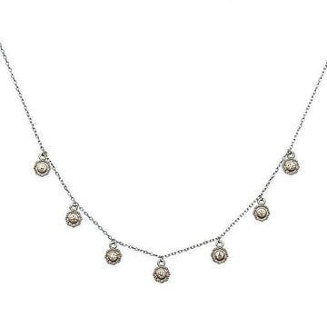 Mini Crystals silver necklace with delicate chain and seven small, ornate pendants.
