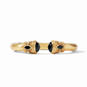 Gold cuff bracelet with black onyx and pearl accents.
