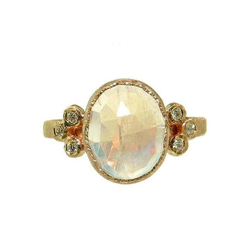 Oval moonstone ring in 18k gold with diamond accents.
