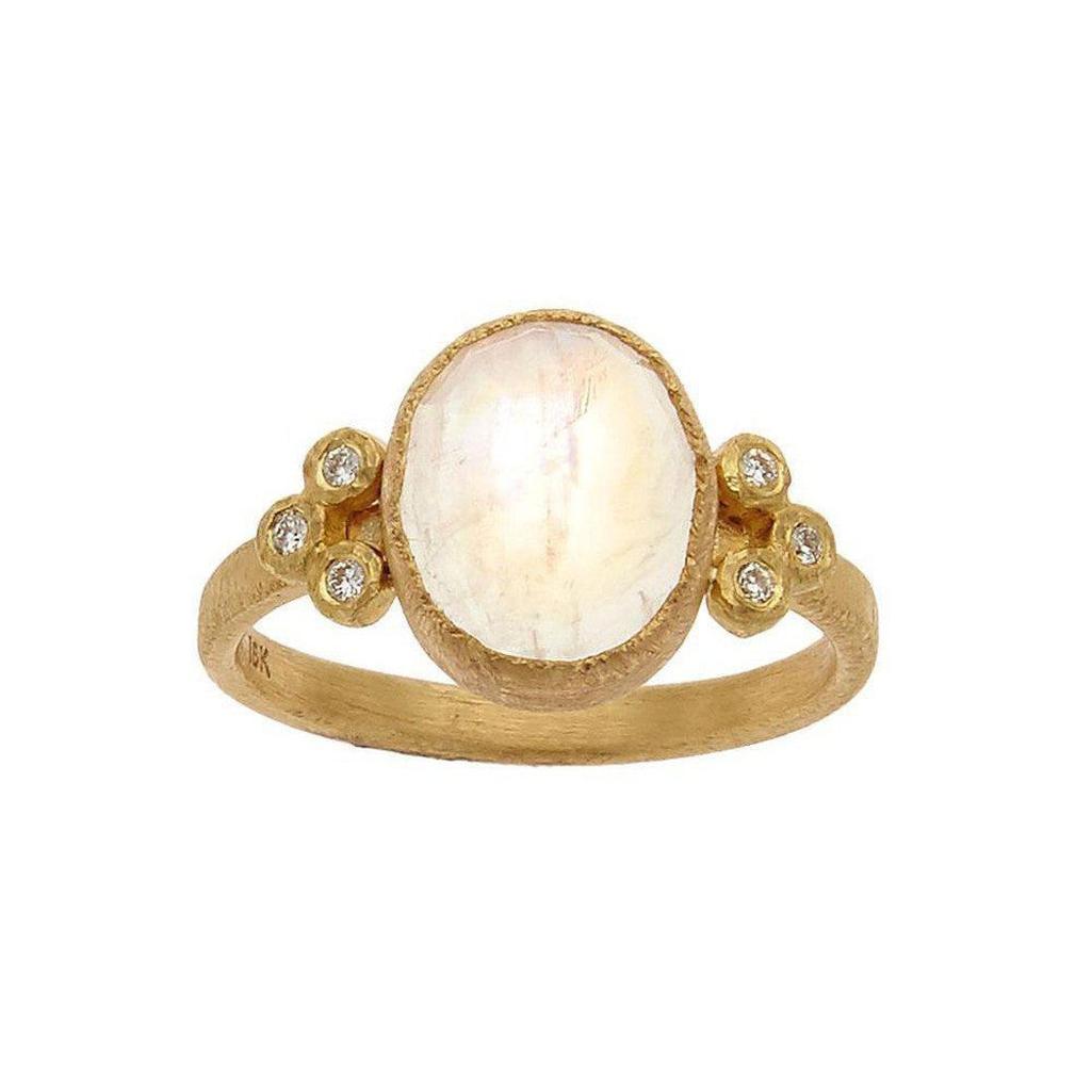 Oval moonstone ring in 18k gold with diamond accents.
