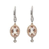 Elegant morganite and diamond earrings: oval morganite center stones, rose gold & white gold, dangling diamond accents.
