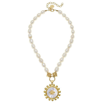 Elegant freshwater pearl necklace featuring a mother-of-pearl bee pendant with gold accents.
