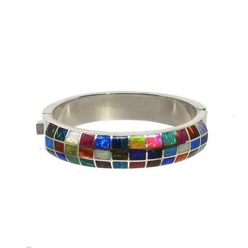 Multicolored stone inlay cuff bracelet with a silver band.
