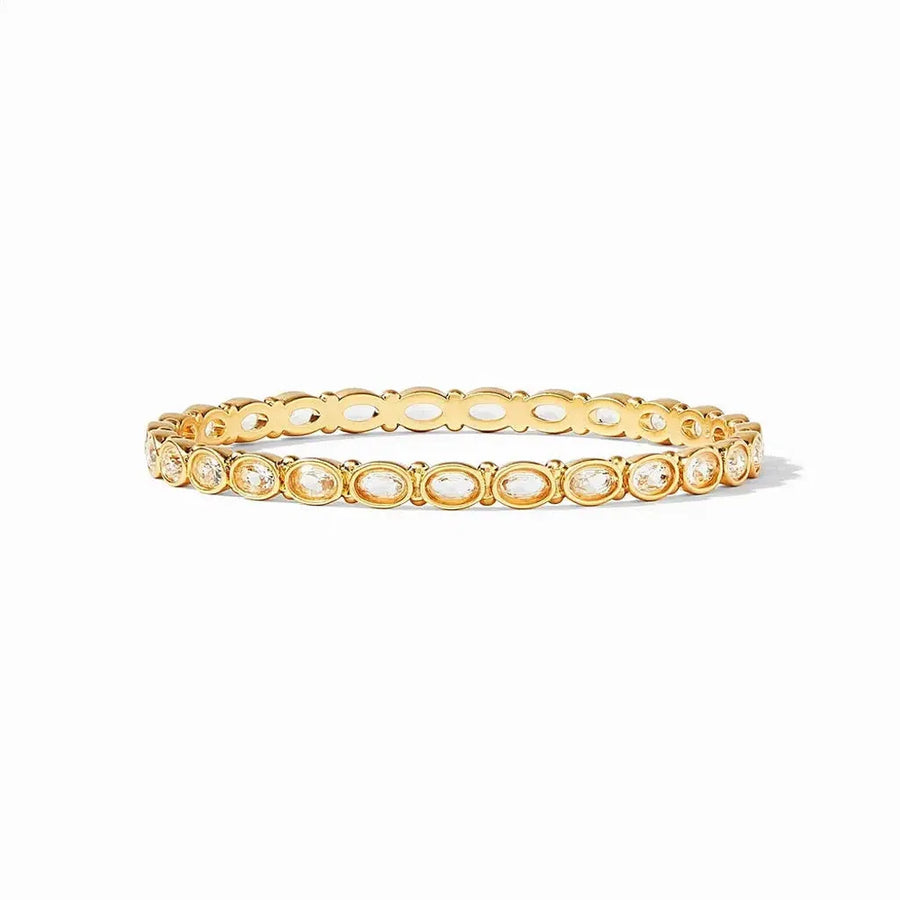 Gold bangle featuring oval-shaped gemstones.

