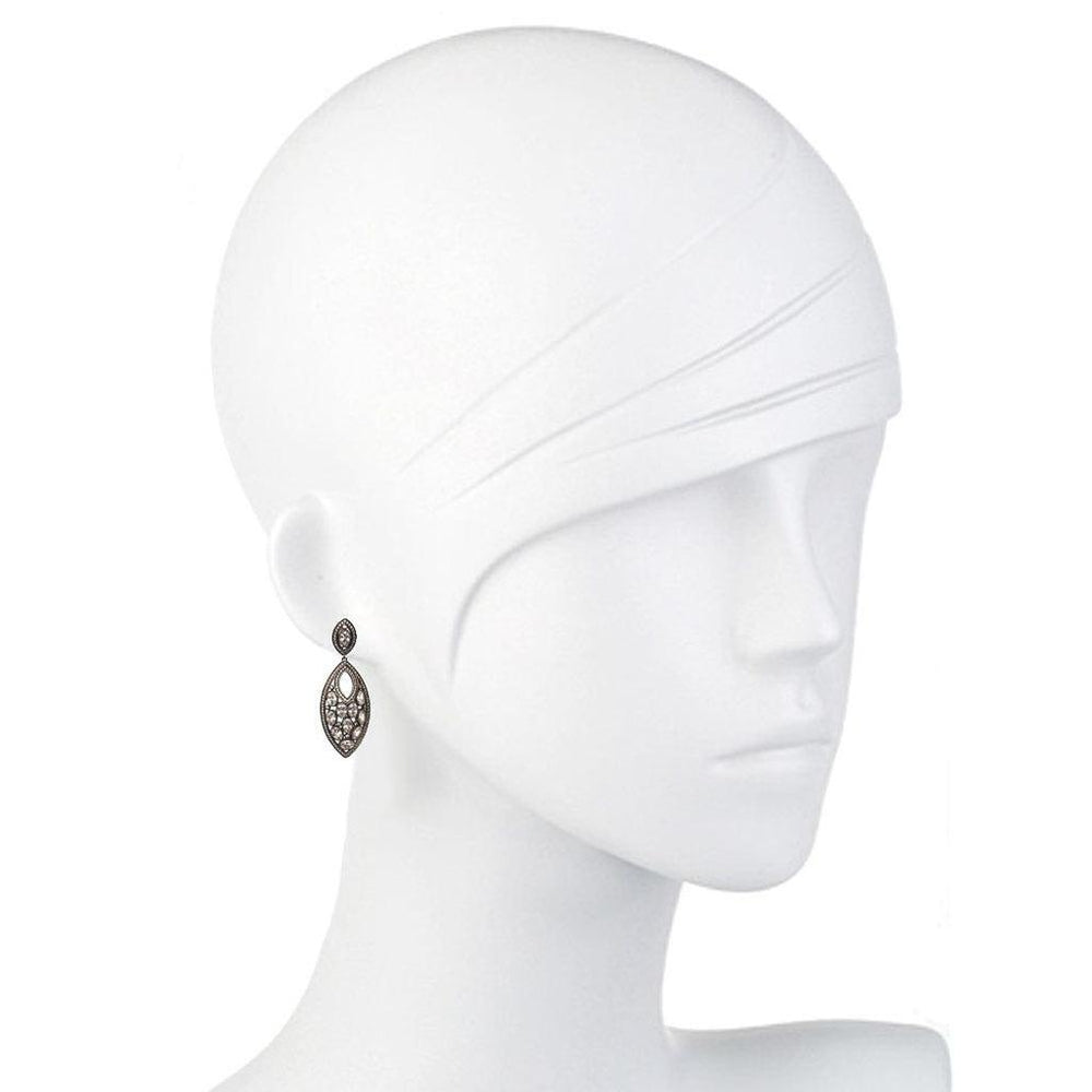 Elegant pave diamond drop earrings on a mannequin.
