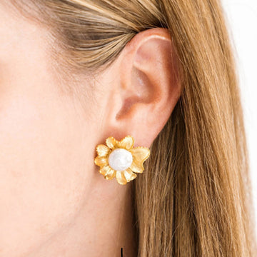 Hand-cast gold plated marigold flower stud earrings with a central white pearl, worn on an earlobe.