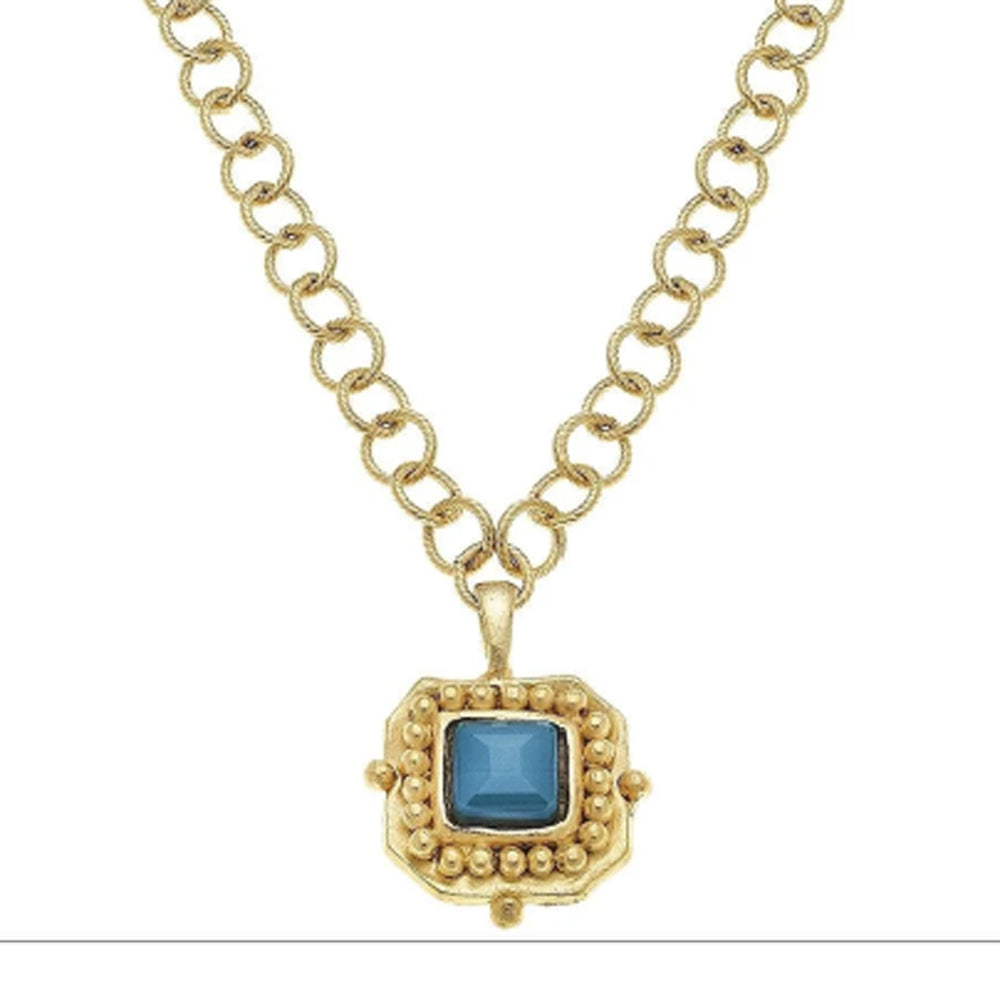 24k gold-plated London pendant necklace featuring a square blue crystal and textured gold link chain.