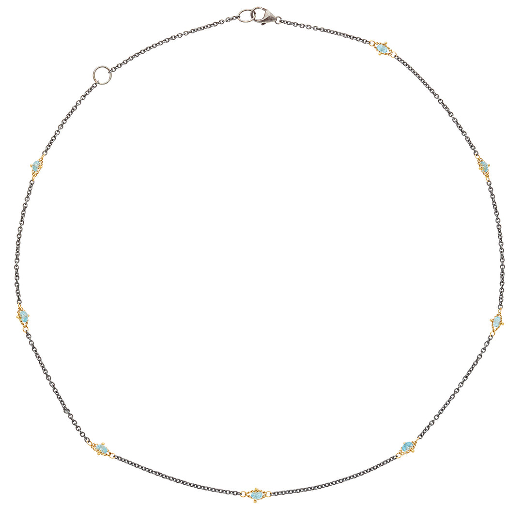 Oxidized sterling silver chain featuring stationed blue topaz gemstones set in 18k gold accents on an 18-inch necklace.