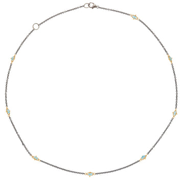 Oxidized sterling silver chain featuring stationed blue topaz gemstones set in 18k gold accents on an 18-inch necklace.