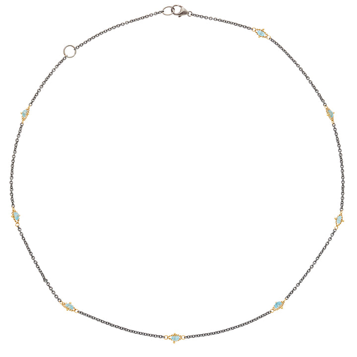 Oxidized sterling silver chain featuring stationed blue topaz gemstones set in 18k gold accents on an 18-inch necklace.