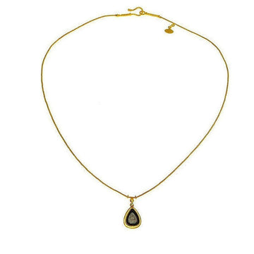 Elegant gold chain necklace featuring a teardrop pendant with a dark gray stone.
