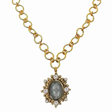Gold chain necklace featuring an antique-style medal pendant adorned with clear crystals.
