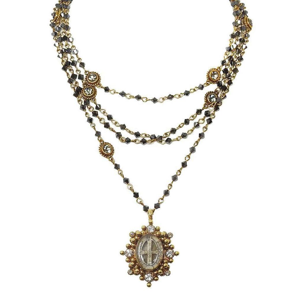Layered gemstone necklace with antique-style pendant.
