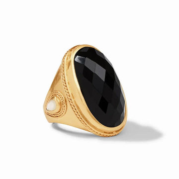 Gold statement ring featuring a large black gemstone and small white accent.
