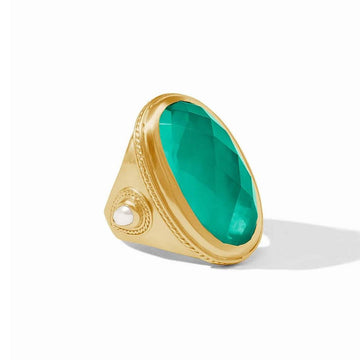 Gold statement ring featuring a large, faceted green gemstone.

