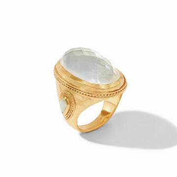Gold statement ring featuring a large oval milky quartz gemstone, detailed with ornate gold accents.
