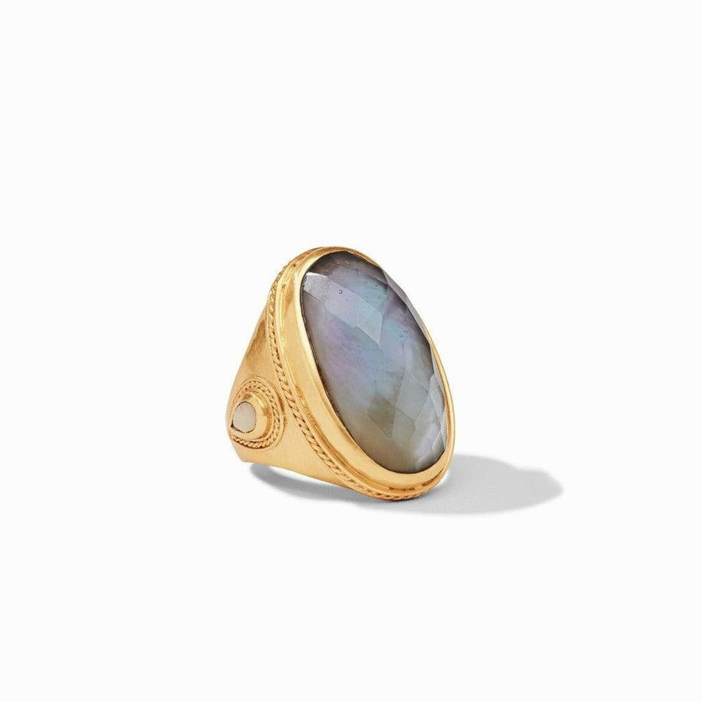 Gold statement ring featuring a large, faceted dark gray gemstone.
