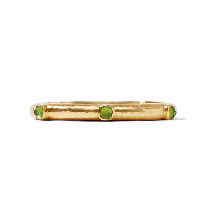 Gold hinged bangle featuring three green gemstones.
