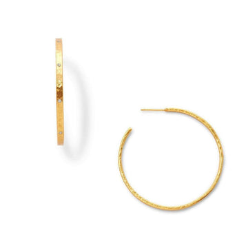 Gold hammered hoop earrings with small diamond accents.
