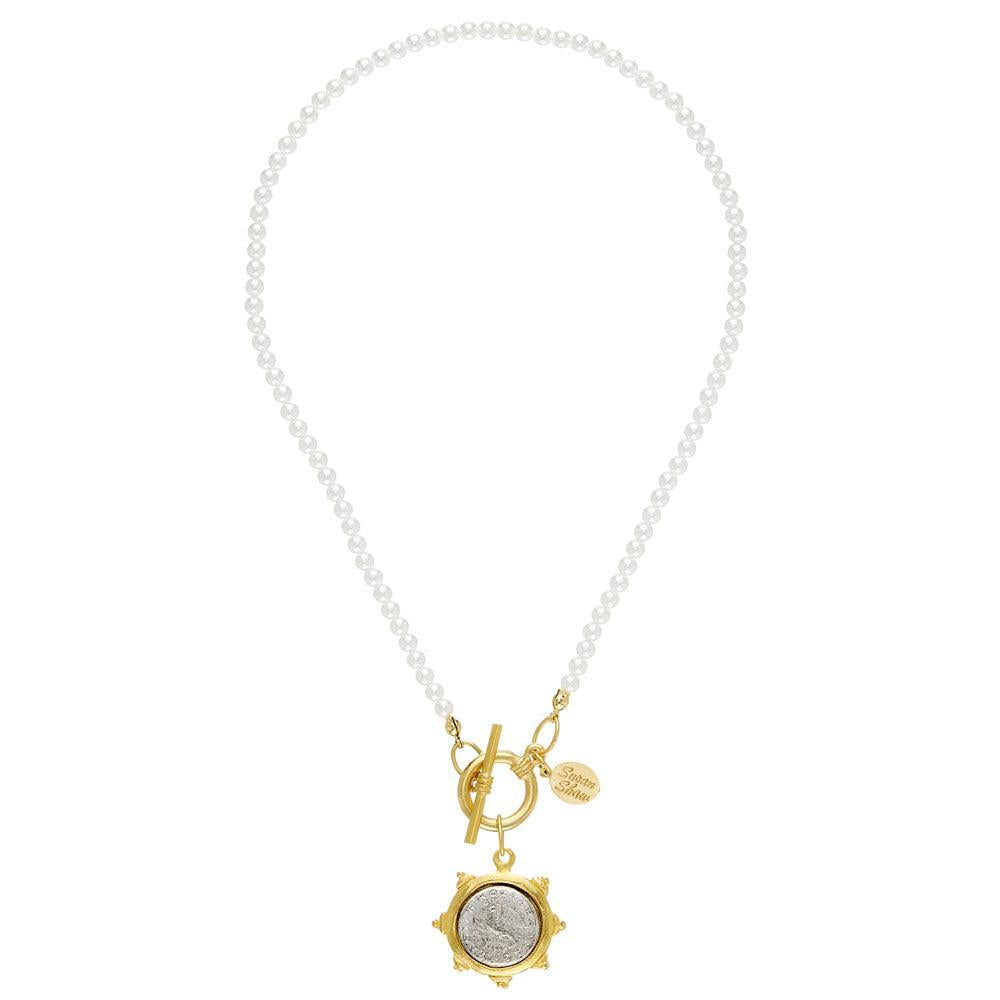 Elegant pearl necklace with gold coin pendant and toggle clasp.
