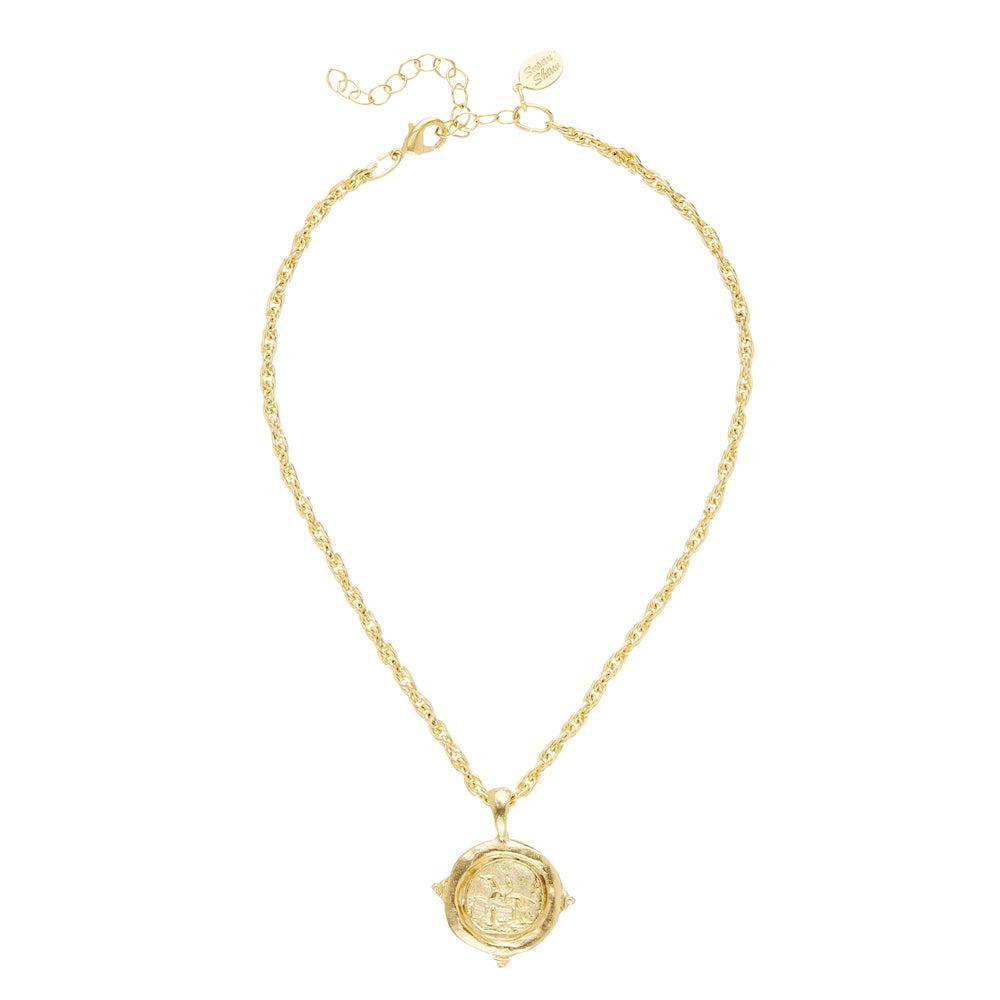 Gold equestrian rope chain necklace with ornate medallion pendant.

