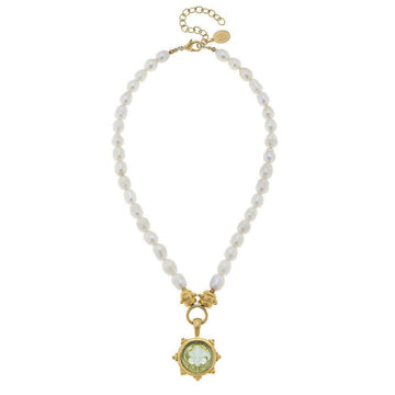 Elegant pearl necklace with gold Venetian glass pendant featuring a green stone.
