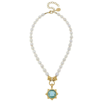 Elegant pearl necklace with a Venetian glass pendant featuring a light blue gemstone.
