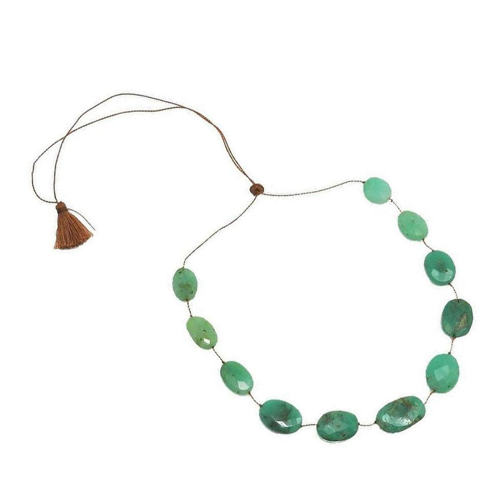 Floating Chrysoprase Tassel Necklace featuring green gemstone beads and brown cord.
