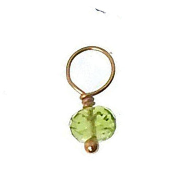 Green gemstone charm with gold wire setting.
