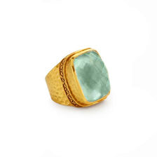 Catalina statement ring with a faceted light green stone in a hammered 24k gold plated band.