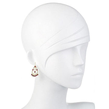 Garnet drop earrings on a mannequin, showcasing rich red gemstone accents and gold detailing.
