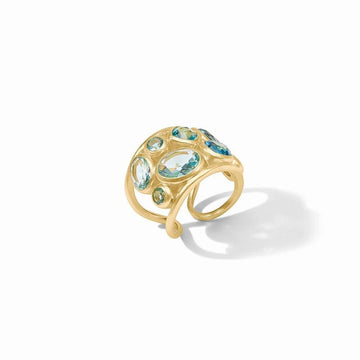 Gold statement ring featuring blue gemstones;  organic design.
