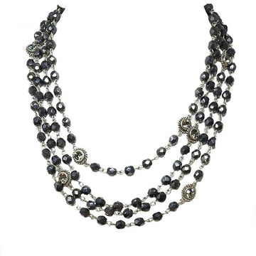 Multi-strand dark gray crystal necklace with silver accents.
