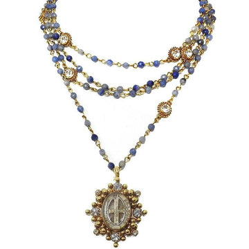 Layered blue stone and gold beaded necklace with antique medallion pendant.
