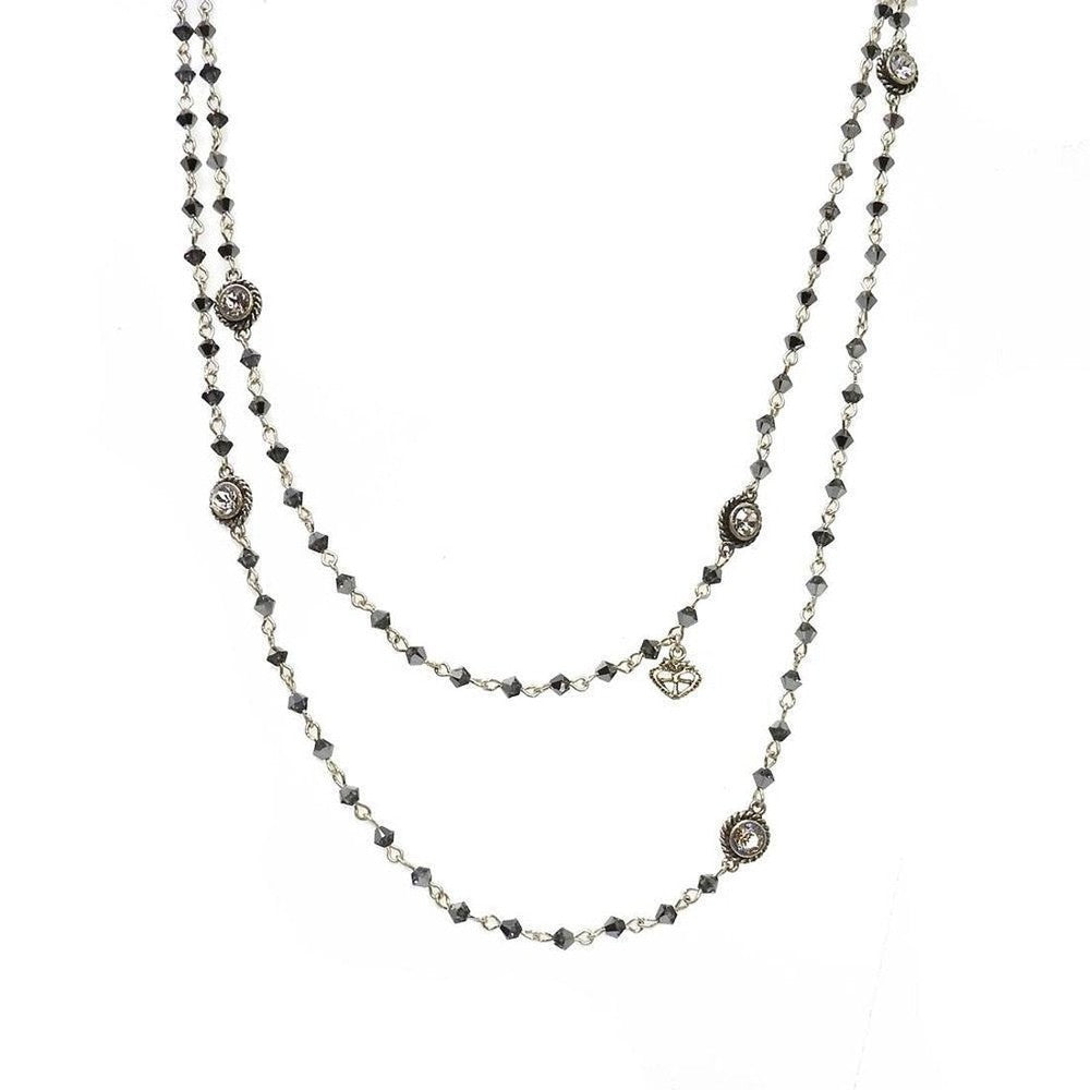 Double-strand necklace with dark gray crystals and silver accents.

